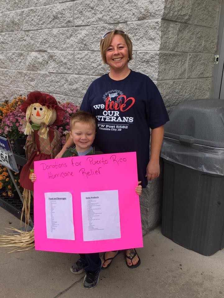 Employee with kid and sign for hurricane relief
